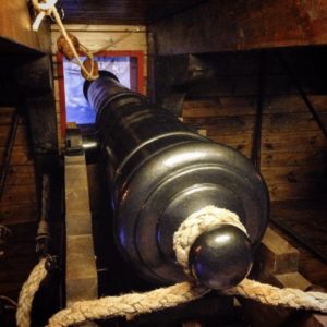 a cannon in a wooden room